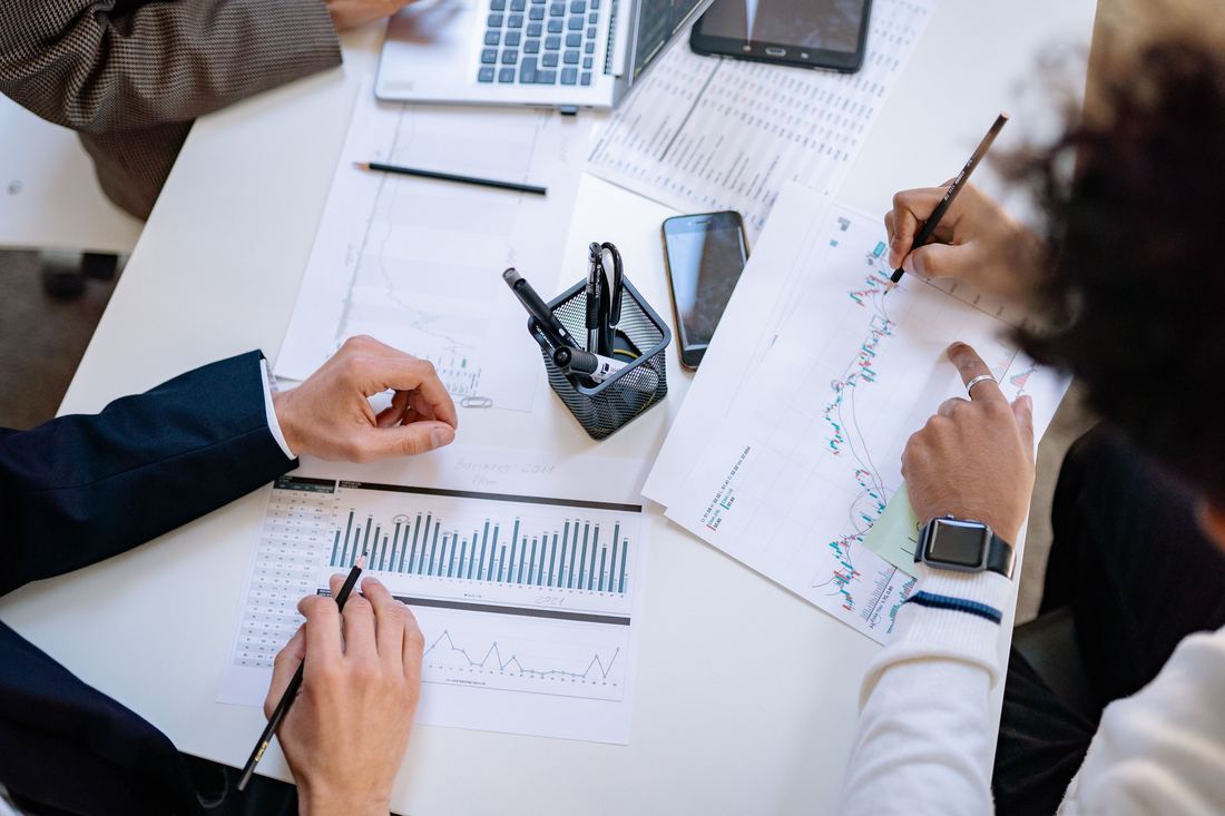 Team reviewing market performance charts and sales reports